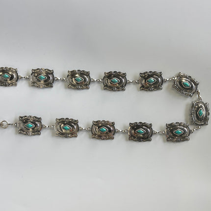 Cinturón metálico plateado con rombo turquesa