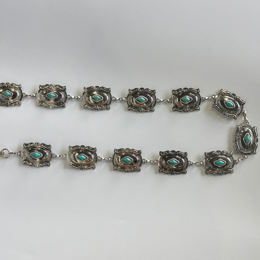 Cinturón metálico plateado con rombo turquesa