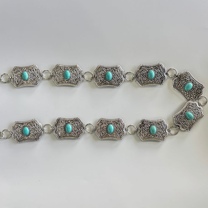 Cinturon metálico rectangular con ovalo turquesa