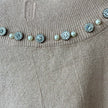 Top cuello alto con aplicaciones