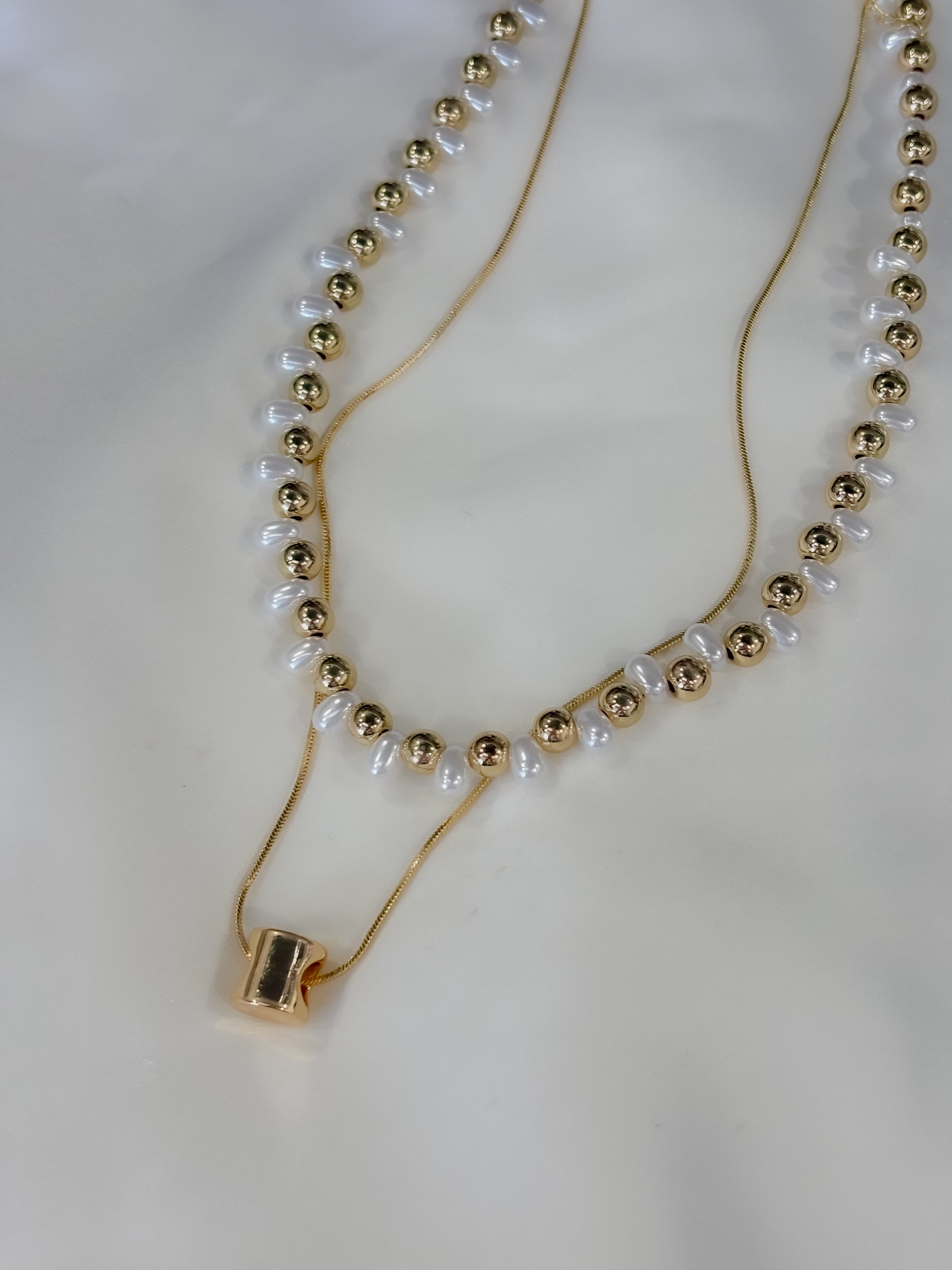Collar doble perla y figuras