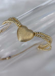 Pulsera tejida con balines y corazón